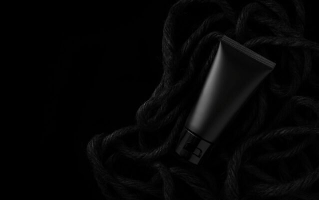 Black cream tube on black pile of ropes. For mockup. Black cream tube on black pile of ropes. For mockup.
